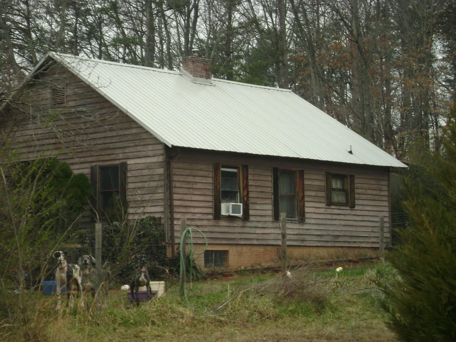 White metal roof on an old wood sided farmhouse, from a Metal Roof Installation job in Centreville